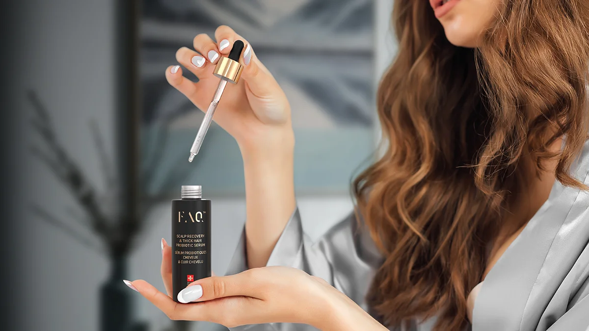 A woman opening the FAQ best hair serum